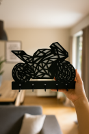 Black MDF keychain hanger with hand-held geometric motorcycle figure, decorative organizer with multiple hooks at the bottom